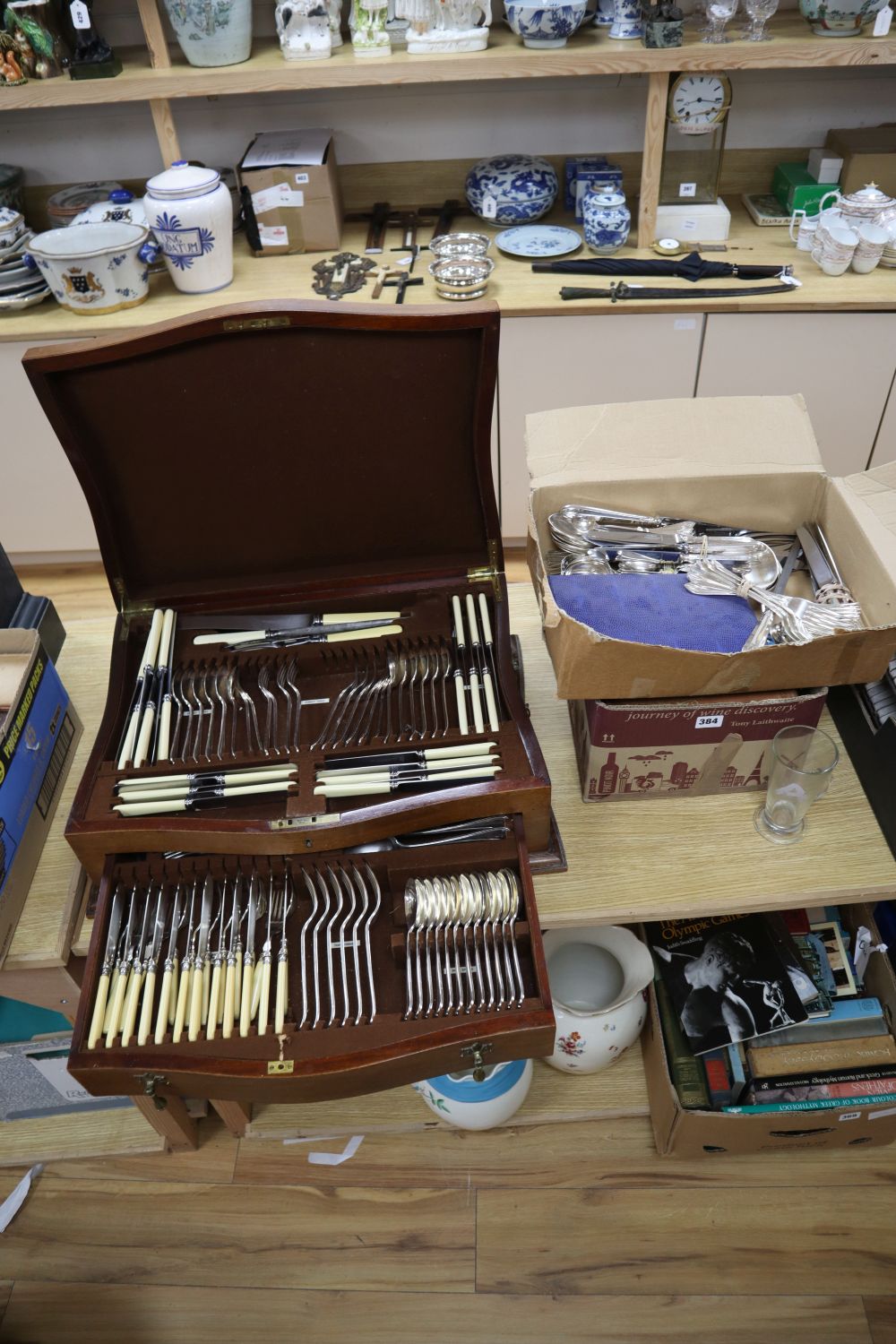 A canteen of cutlery on stand and assorted plated cutlery